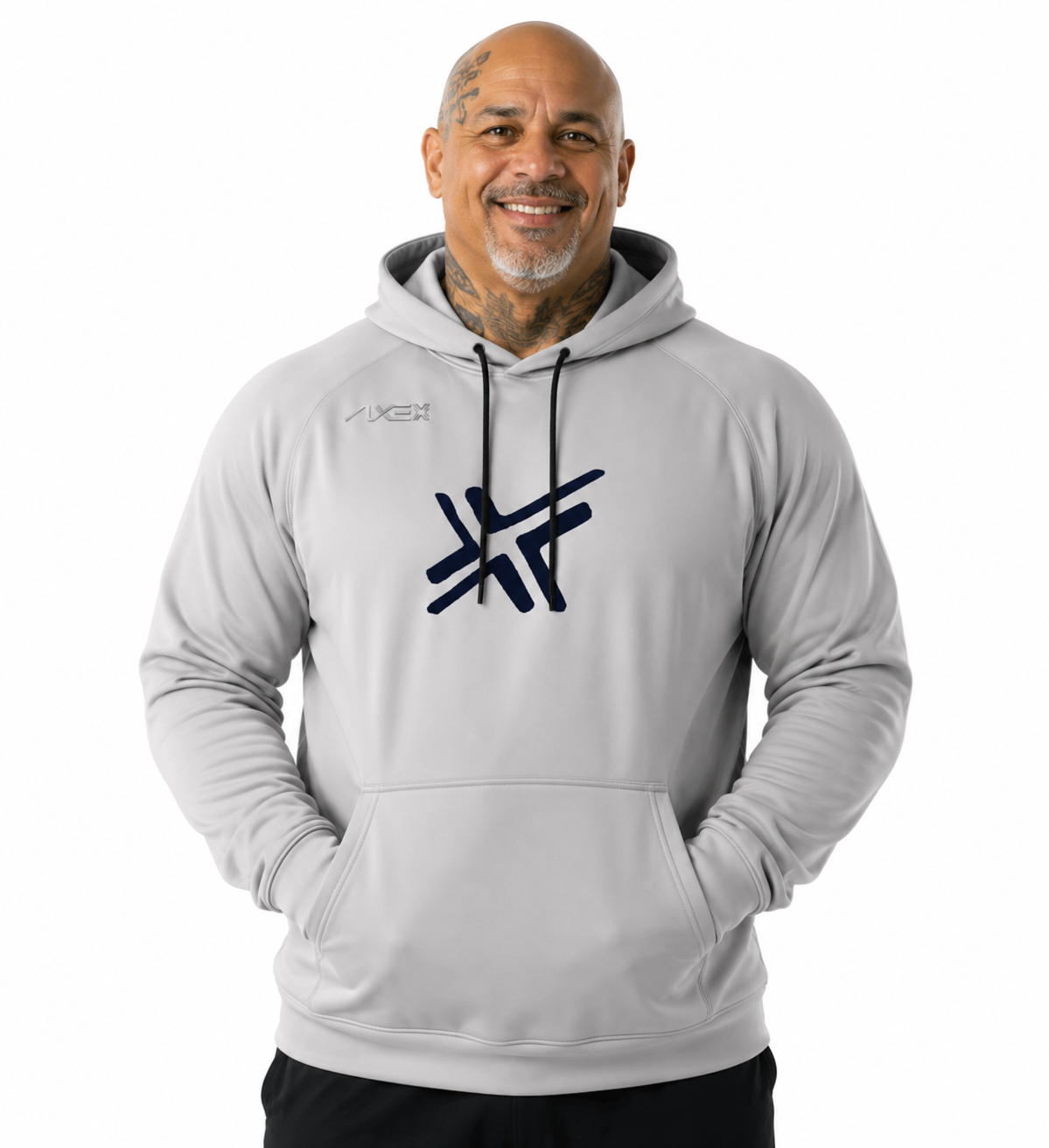 A smiling man wearing a light gray pullover hoodie with a dark navy graphic logo on the chest and a smaller logo on the left chest, photographed against a plain white background.