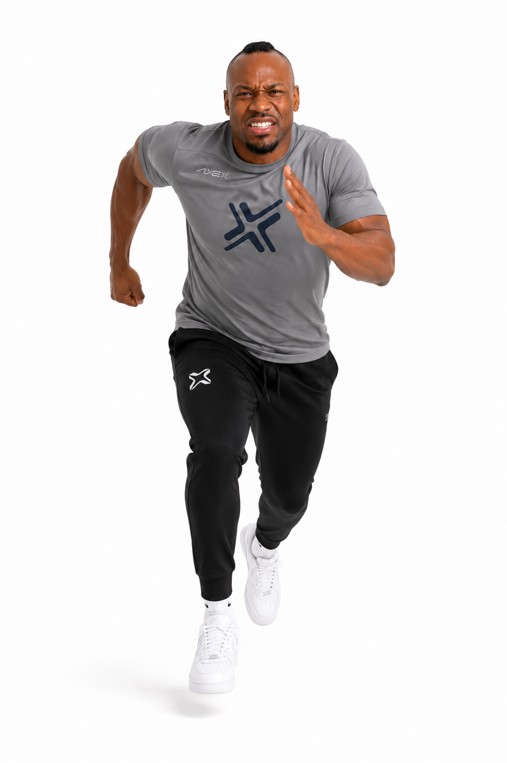 A man running forward in a gray athletic t-shirt with a dark blue logo and black jogger pants with white sneakers, on a solid white background.