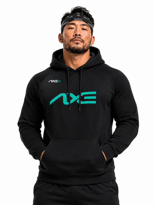 Man wearing the black Axe Scuba Hoodie with the teal AXE logo across the chest, paired with black Axe joggers.