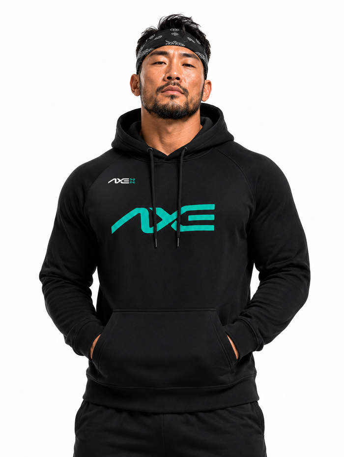 Man wearing the black Axe Scuba Hoodie with the teal AXE logo across the chest, paired with black Axe joggers.