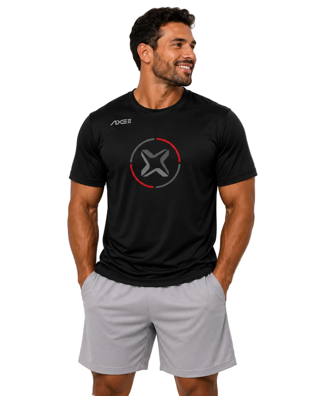 A man wearing a black athletic t-shirt with a circular logo on the chest and light gray athletic shorts, standing against a light gray studio background.