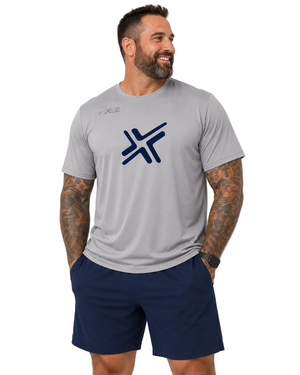 A man wearing a light gray athletic t-shirt with a dark blue stylized 'X' logo on the chest, paired with navy blue shorts, photographed against a light gray studio background.
