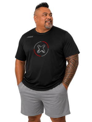 A man wearing a black short-sleeve athletic t-shirt with a circular logo on the chest and gray shorts, standing against a plain white background.