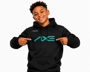 A smiling young man wearing a black hoodie with a large teal and white AXE logo on the chest, pointing at the logo with both hands against a plain white background.