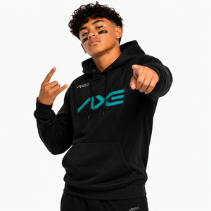A young man wearing a black hoodie with a large teal and white AXE logo on the chest, posing against a light gray background.