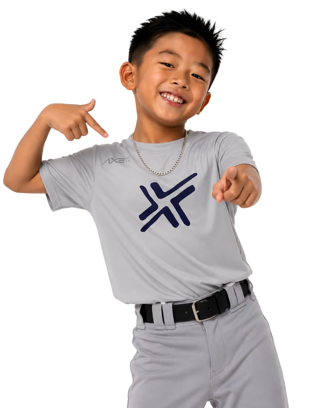 A smiling young boy wearing a light gray athletic t-shirt with a dark navy blue stylized logo on the chest, paired with gray baseball pants and a black belt, posing against a solid white background.