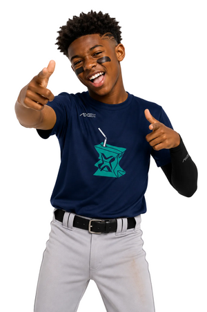 A smiling young man wearing a navy blue athletic t-shirt with a teal star graphic and a black long-sleeve undershirt, paired with gray baseball pants, posing against a white background.