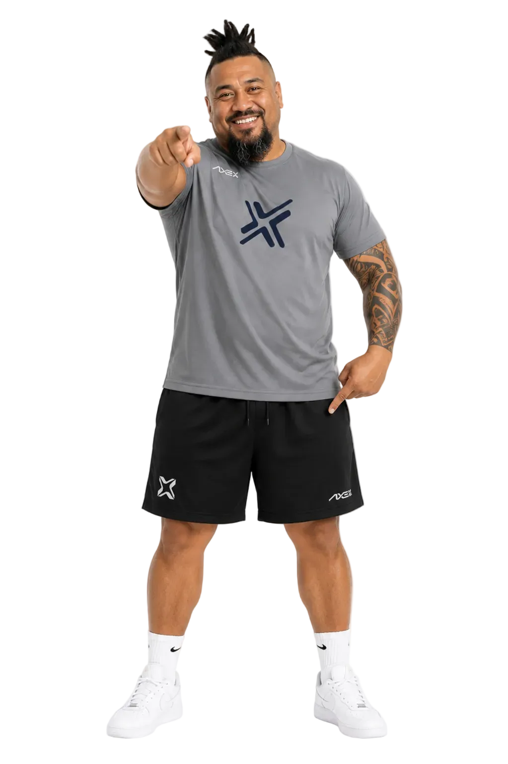 A man wearing a gray athletic t-shirt with a dark blue logo and black shorts, pointing directly at the camera against a plain white background.