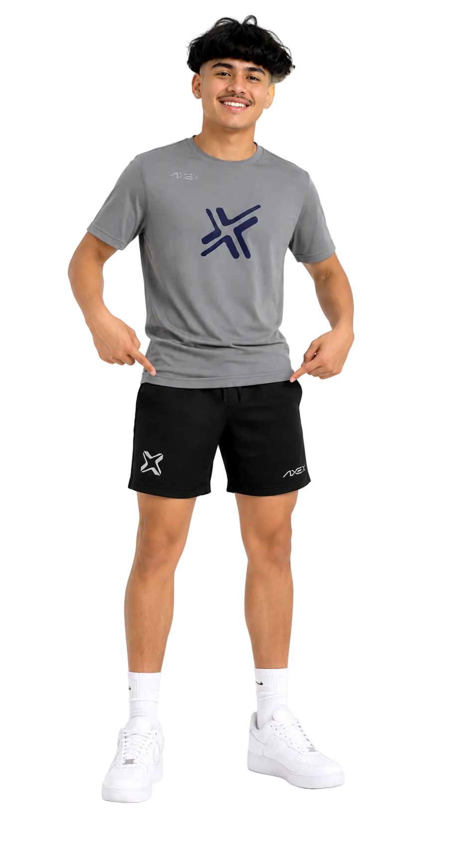 A man modeling a gray short-sleeve athletic t-shirt and black athletic shorts with a matching logo, paired with white socks and white sneakers, against a plain white background.