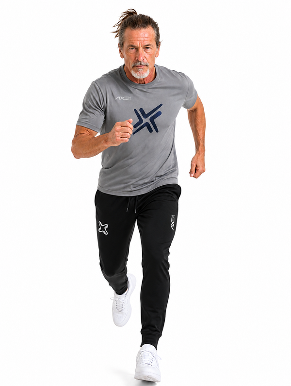 Man running in black Axe Joggers with the white Axe X mark at the left thigh, paired with a gray G1 Axe performance tee.