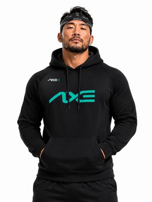 Man wearing the black Axe Scuba Hoodie with the teal AXE logo across the chest, paired with black Axe joggers.