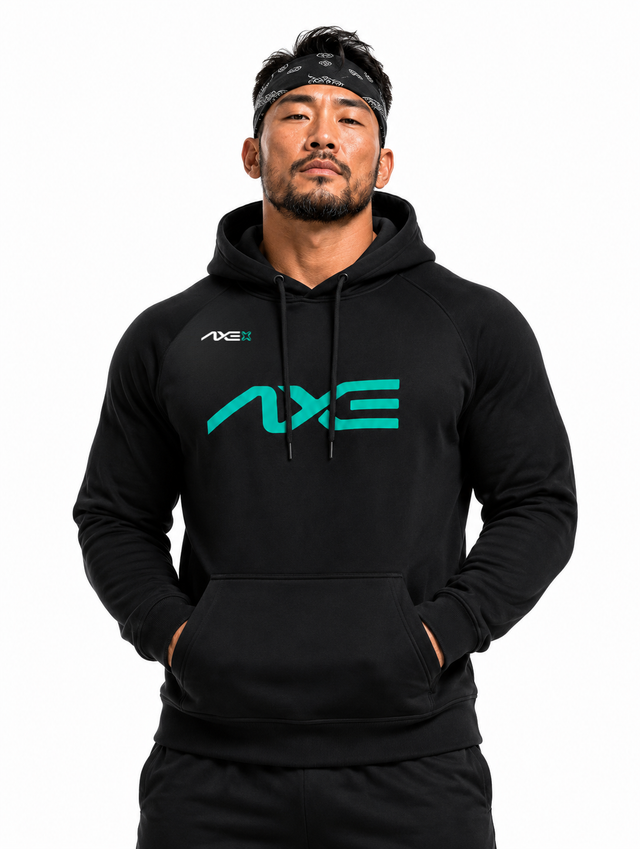 Man wearing the black Axe Scuba Hoodie with the teal AXE logo across the chest, paired with black Axe joggers.