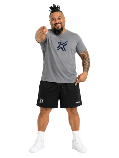 Man wearing black Axe Training Shorts with the white Axe X mark at the left hem, paired with a gray Axe performance tee.