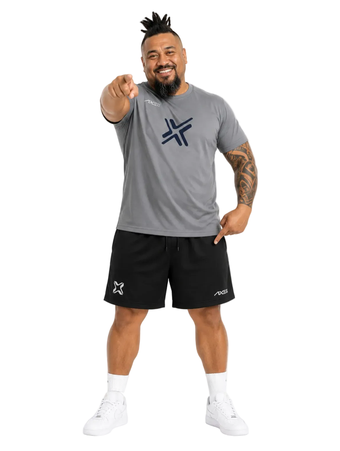 Man wearing black Axe Training Shorts with the white Axe X mark at the left hem, paired with a gray Axe performance tee.