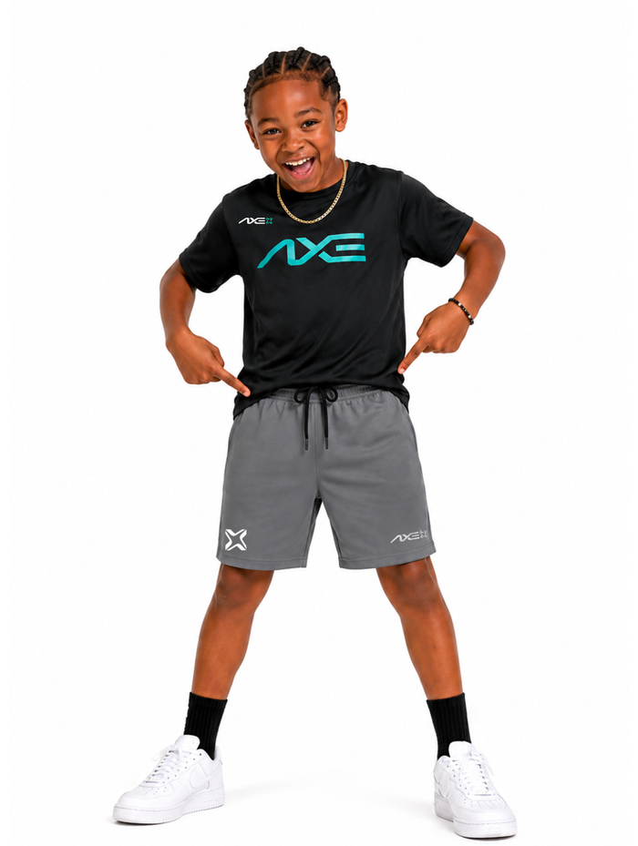 Young ballplayer wearing gray youth Axe Training Shorts with the white Axe X mark at the left hem, paired with a black Axe performance tee.